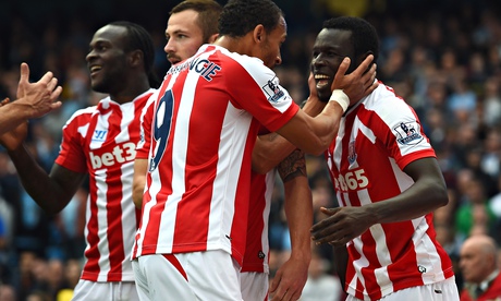 Stoke City's Mame Biram Diouf, right, celebrates scoring against Manchester City
