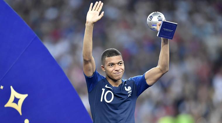 France's Kylian Mbappe poses with the best young player award